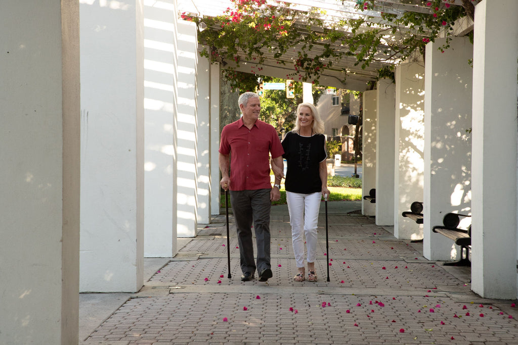 man and woman walking with canes