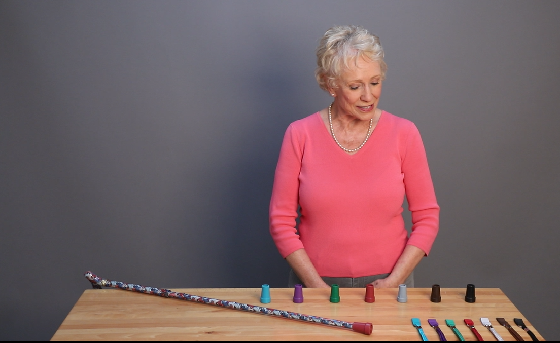 A lady showing different color walking cane tips and styles