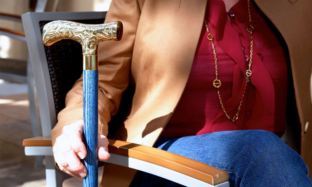 holding trendy cane